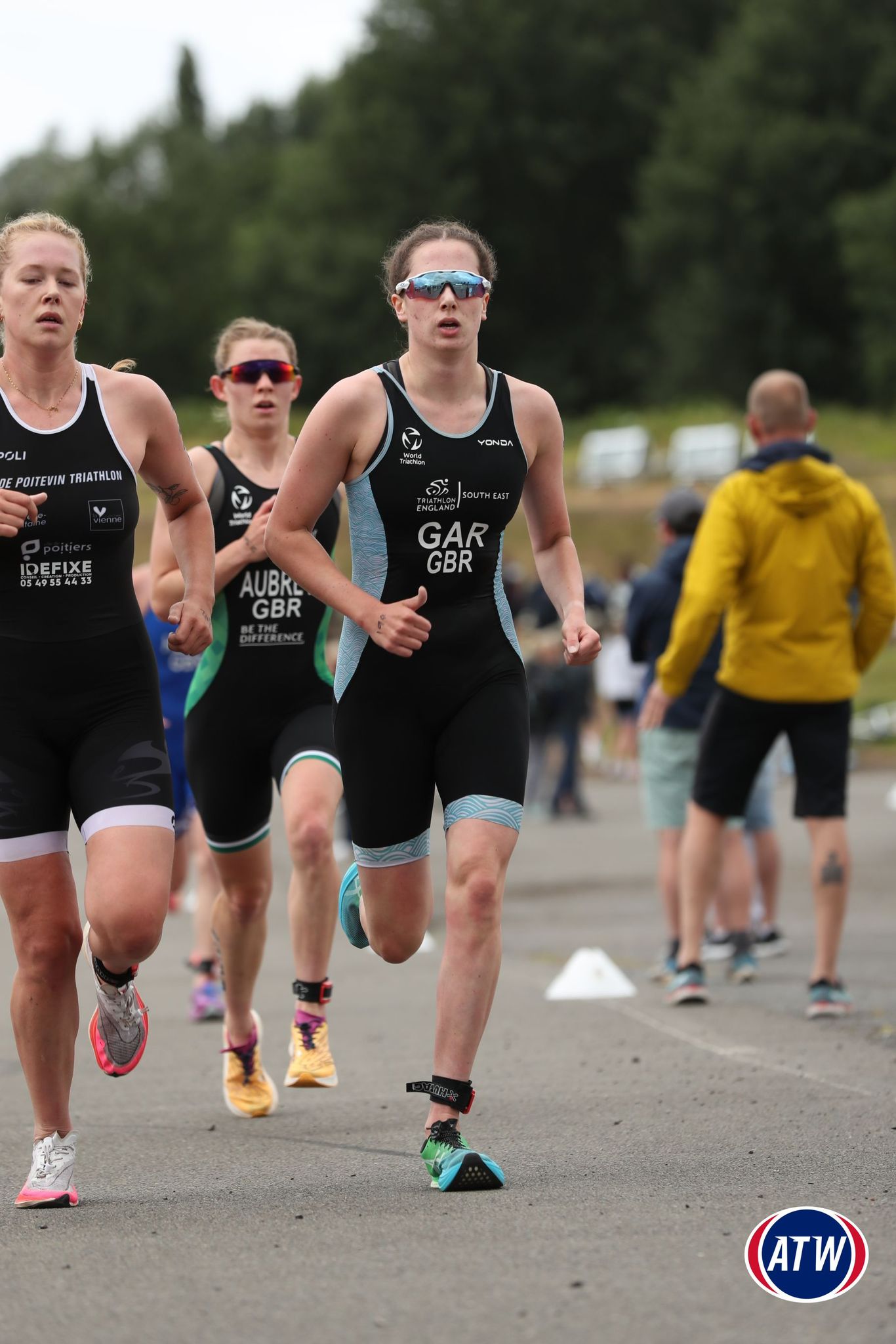Bella Gar leading the run leg at an international triathlon race, wearing Great Britain racing kit